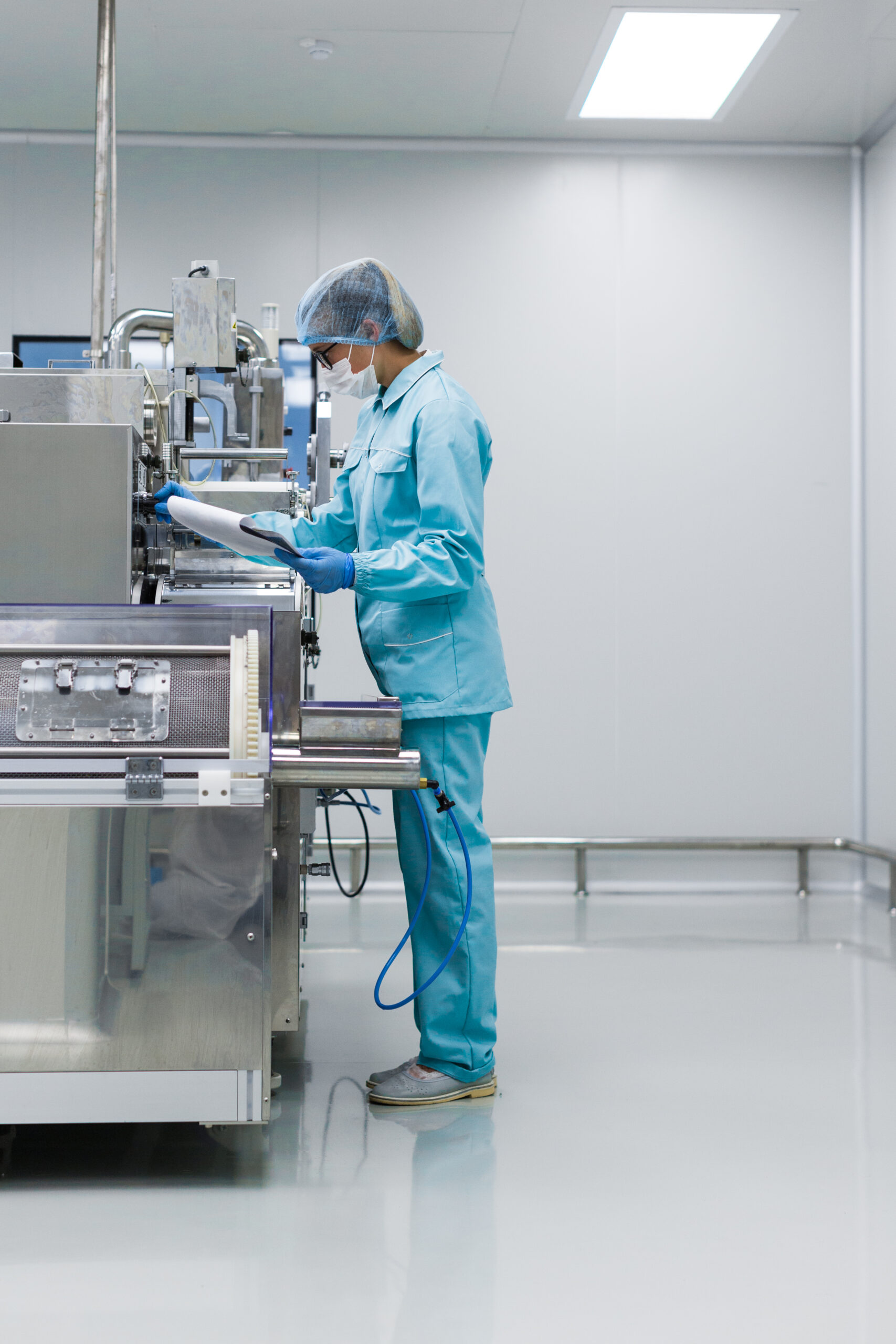 scientist in med suit working with machine